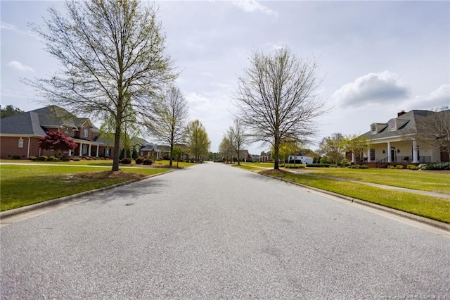 view of road with a residential view, curbs, and sidewalks
