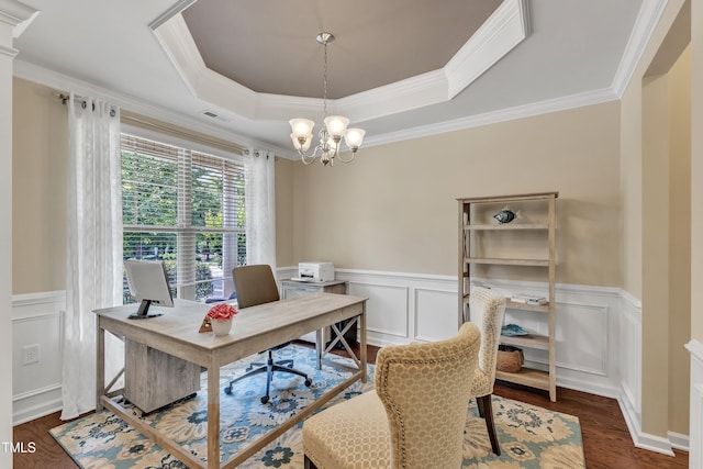 office area with a tray ceiling, crown molding, a chandelier, wainscoting, and wood finished floors