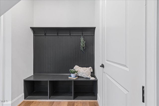 mudroom with wood finished floors and baseboards