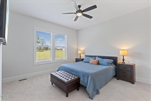 bedroom with baseboards, light carpet, and ceiling fan