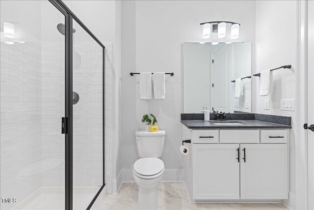 bathroom featuring marble finish floors, a shower stall, toilet, and vanity