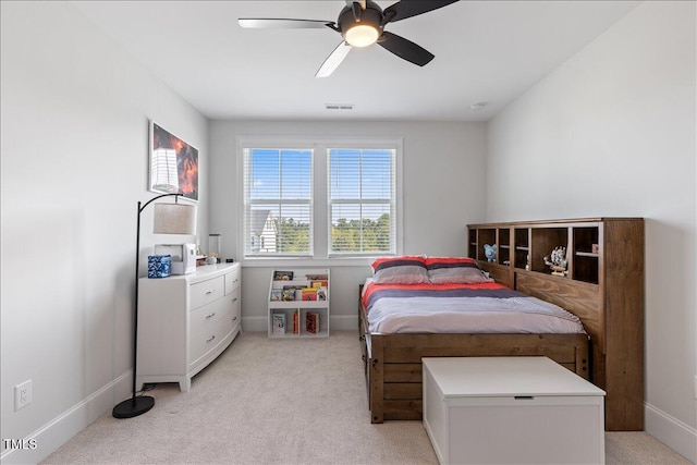 bedroom with light carpet, baseboards, and a ceiling fan