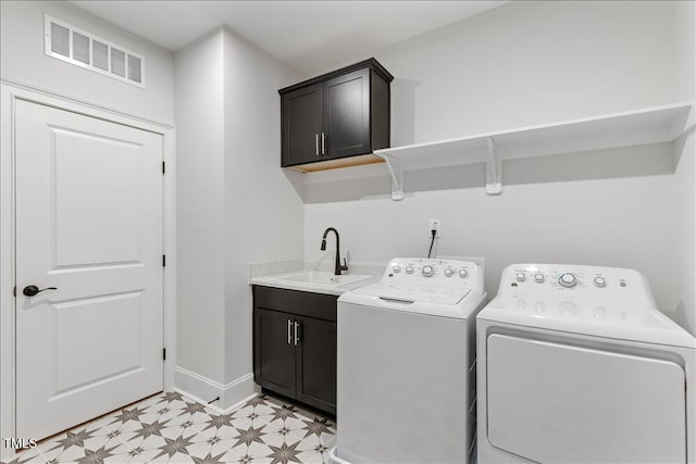 washroom with washing machine and dryer, cabinet space, light flooring, and baseboards