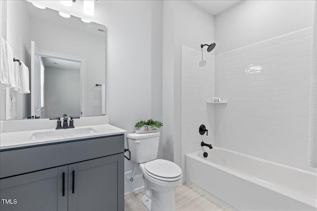 bathroom featuring toilet, washtub / shower combination, and vanity