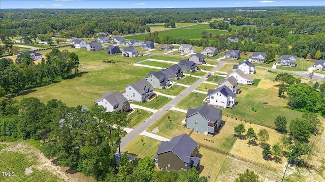 aerial view of property and surrounding area featuring nearby suburban area