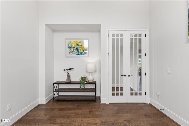 entryway featuring french doors, dark wood-type flooring, and baseboards