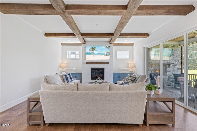 living area with a fireplace, coffered ceiling, baseboards, beam ceiling, and wood finished floors