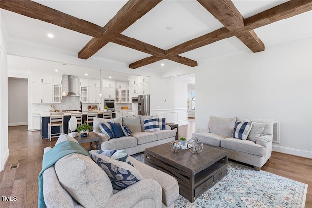 living room featuring coffered ceiling, beamed ceiling, wood finished floors, recessed lighting, and baseboards