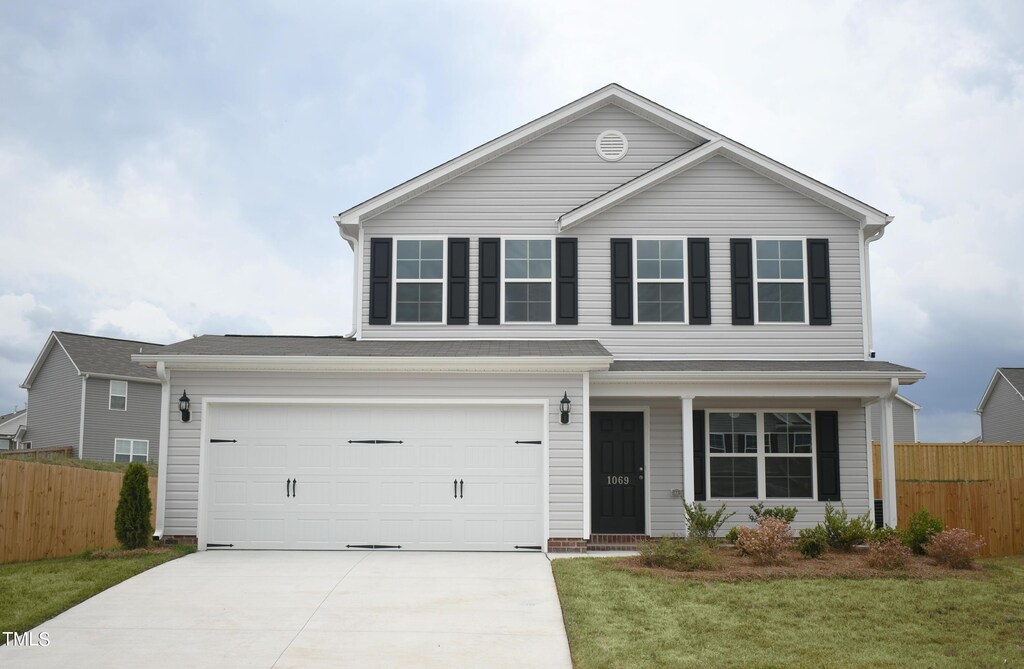1069 Thicket Dr Unit 355, Burlington, NC 27217 - traditional-style home with fence, an attached garage, concrete driveway, and a front yard