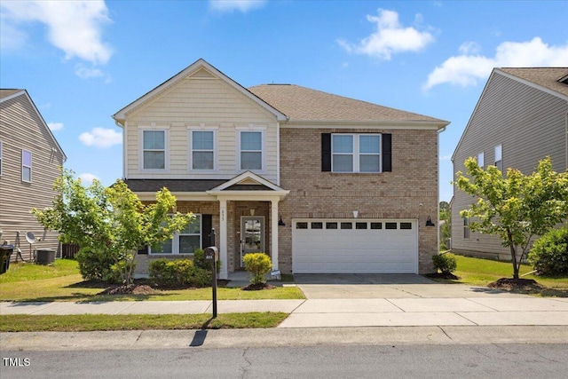 833 Ember Dr, Durham, NC 27703 - view of front of home with an attached garage, brick siding, and concrete driveway