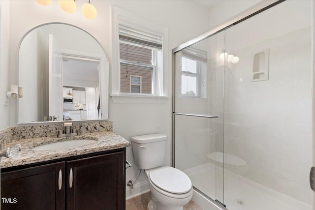 833 Ember Dr, Durham, NC 27703 - full bathroom with toilet, vanity, a stall shower, and baseboards