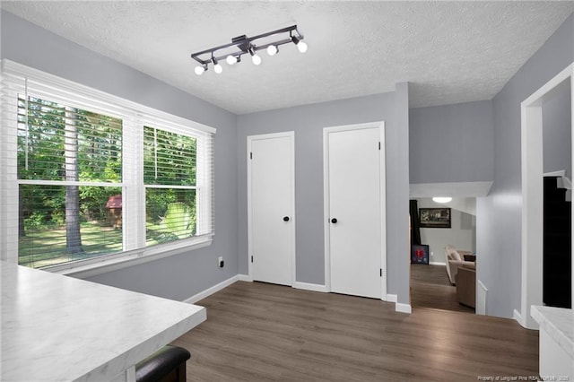 1618 Hickory Ridge Ct, Fayetteville, NC 28304 - unfurnished dining area featuring wood finished floors, a textured ceiling, and baseboards