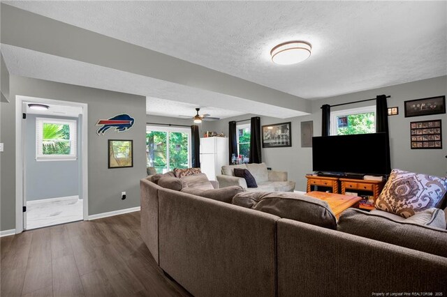 1618 Hickory Ridge Ct, Fayetteville, NC 28304 - living room with dark wood-type flooring, a textured ceiling, baseboards, and ceiling fan