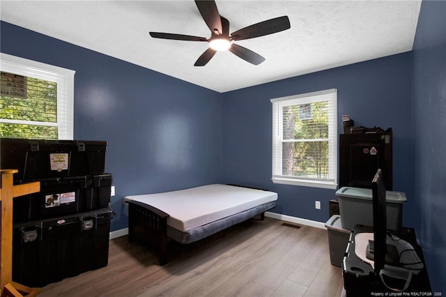 1618 Hickory Ridge Ct, Fayetteville, NC 28304 - bedroom with dark wood-style flooring, baseboards, and a ceiling fan