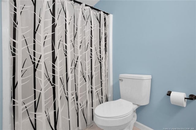1618 Hickory Ridge Ct, Fayetteville, NC 28304 - bathroom featuring toilet, baseboards, and curtained shower