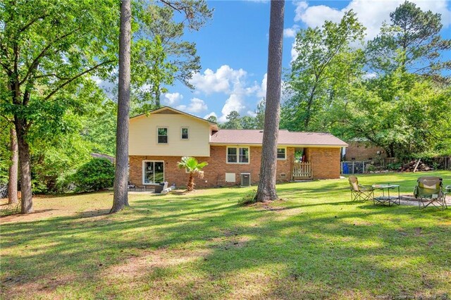 1618 Hickory Ridge Ct, Fayetteville, NC 28304 - back of property featuring brick siding, a lawn, and central air condition unit