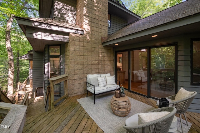wooden terrace with an outdoor hangout area