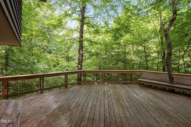 wooden deck featuring a view of trees