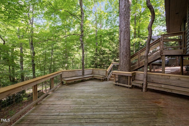 wooden deck with stairs and a forest view