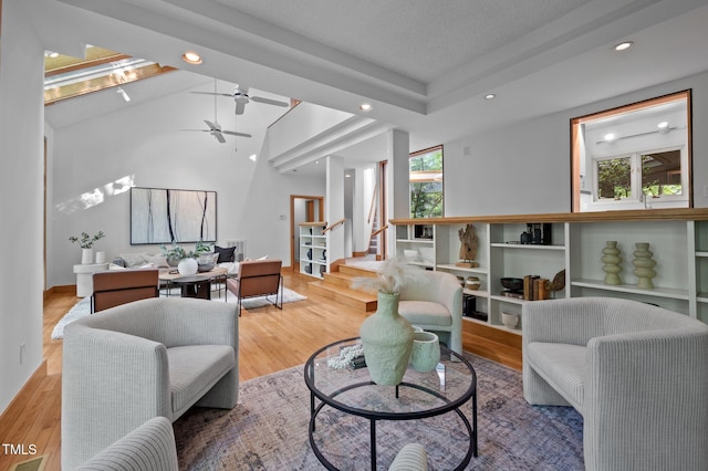living area with plenty of natural light, recessed lighting, wood finished floors, lofted ceiling, and ceiling fan