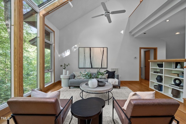 living room with high vaulted ceiling, a ceiling fan, wood finished floors, and recessed lighting