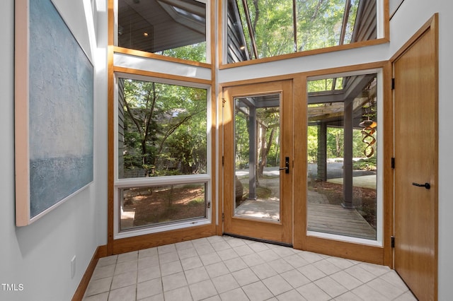 doorway to outside featuring light tile patterned flooring and healthy amount of natural light