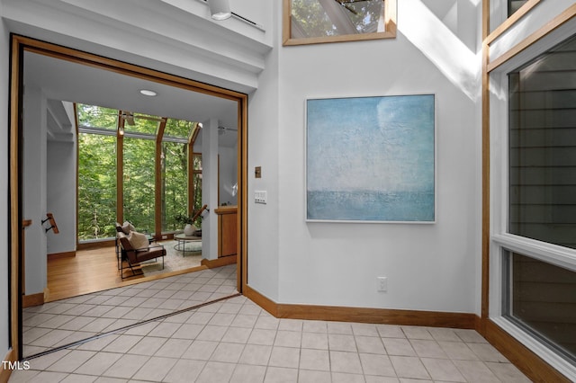 entryway featuring light tile patterned floors and baseboards