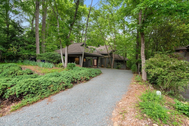 view of front of property with driveway and roof with shingles