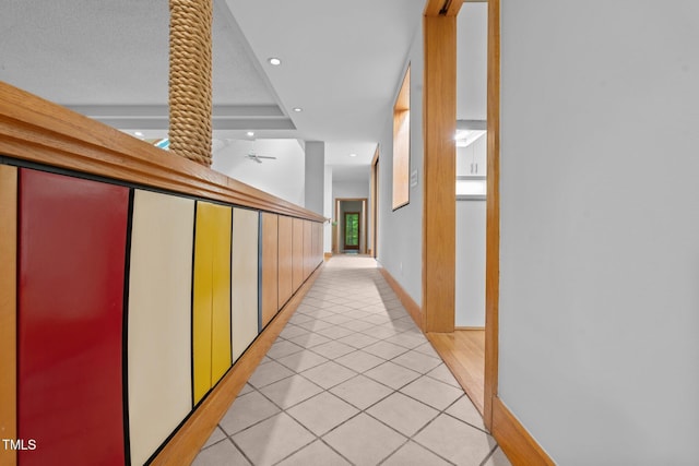 corridor featuring light tile patterned floors, recessed lighting, and baseboards