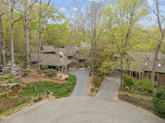 view of front of home with asphalt driveway and a shingled roof