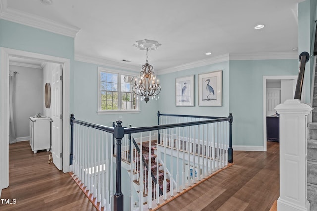 corridor with an upstairs landing, a chandelier, wood finished floors, crown molding, and recessed lighting