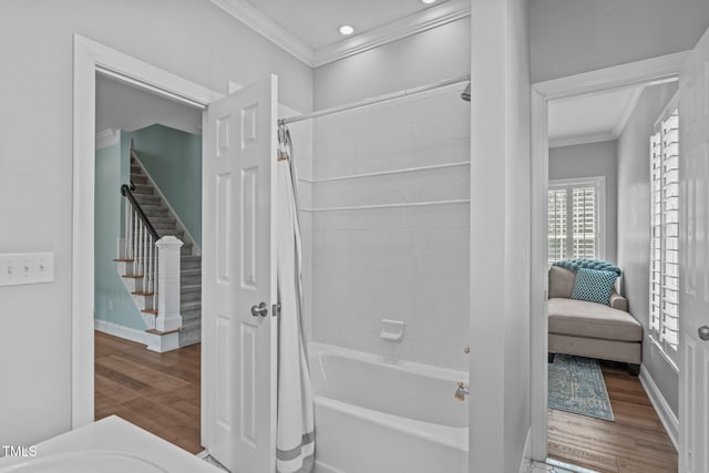 corridor featuring ornamental molding, wood finished floors, stairs, baseboards, and recessed lighting
