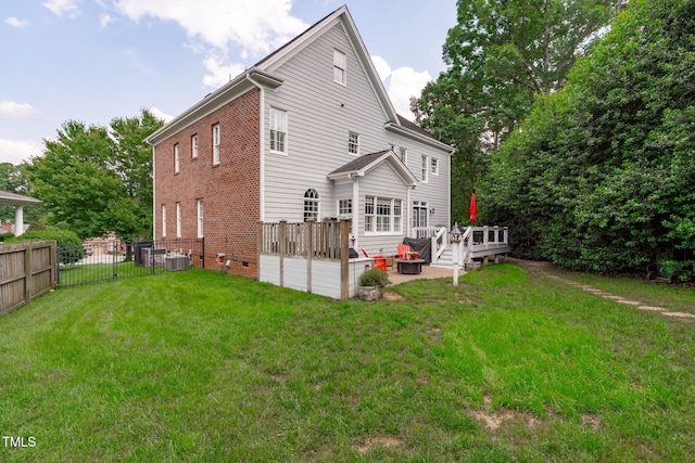 back of house featuring a wooden deck, central air condition unit, and brick siding