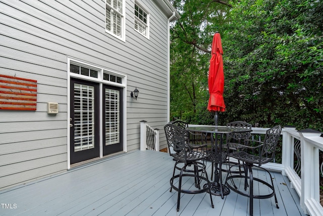 wooden terrace with outdoor dining area