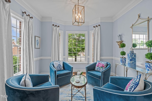 sitting room with a chandelier and crown molding