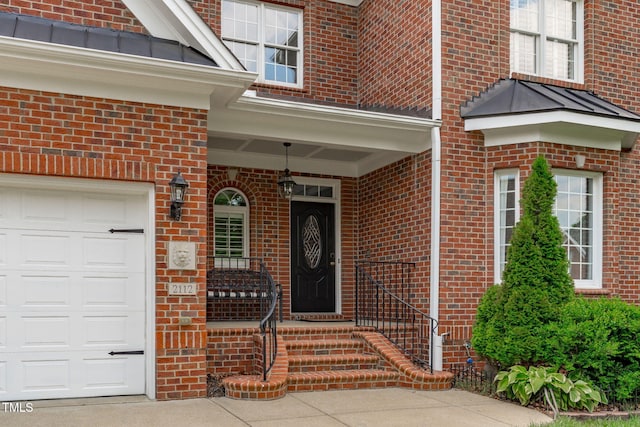 entrance to property featuring brick siding and an attached garage