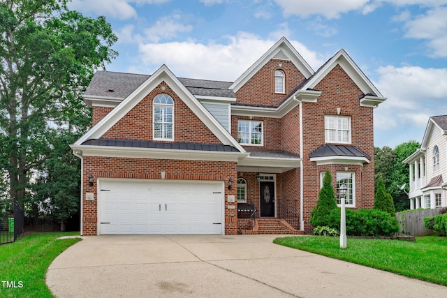 view of front of home with concrete driveway, a garage, brick siding, a standing seam roof, and a shingled roof