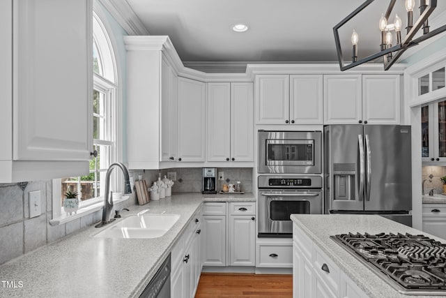 kitchen featuring appliances with stainless steel finishes, a sink, white cabinetry, and recessed lighting