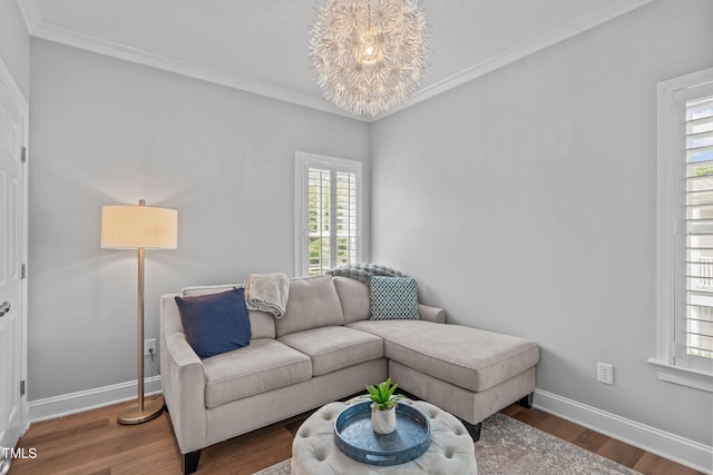 living area featuring baseboards, wood finished floors, and ornamental molding