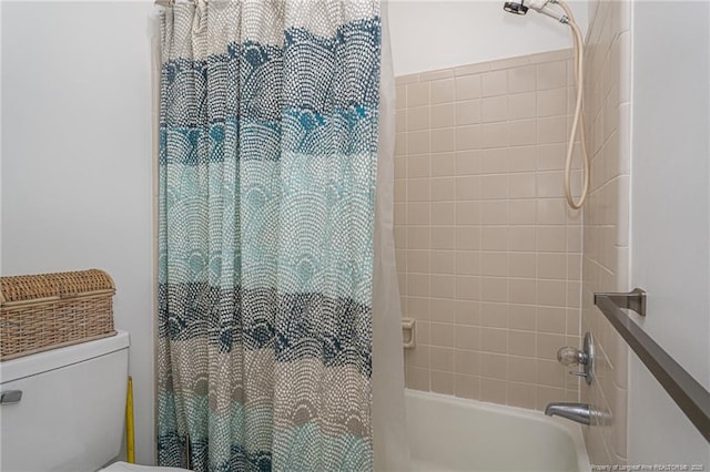 bathroom featuring toilet and shower / bath combo with shower curtain