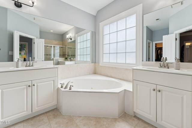 325 Wescott Ridge Dr, Holly Springs, NC 27540 - bathroom featuring a stall shower, two vanities, a jetted tub, and a spacious closet