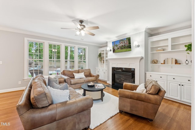 325 Wescott Ridge Dr, Holly Springs, NC 27540 - living area featuring crown molding, ceiling fan, light wood finished floors, and a fireplace with flush hearth