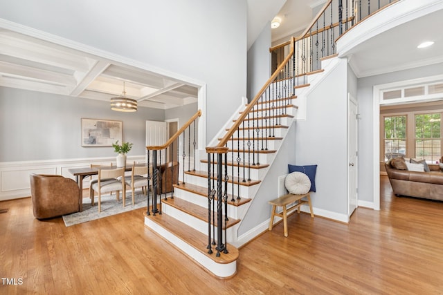 325 Wescott Ridge Dr, Holly Springs, NC 27540 - staircase with coffered ceiling, wood finished floors, a chandelier, crown molding, and beam ceiling