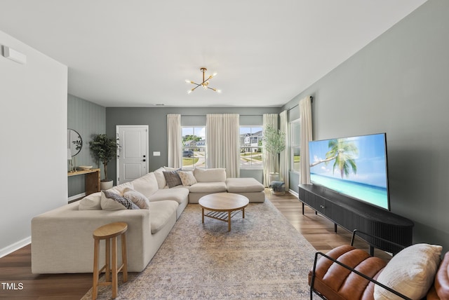 living room with a chandelier, wood finished floors, and baseboards