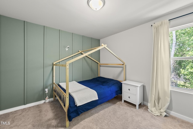 unfurnished bedroom featuring carpet flooring and baseboards