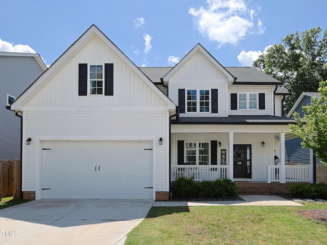 view of front of home featuring covered porch, board and batten siding, concrete driveway, and roof with shingles