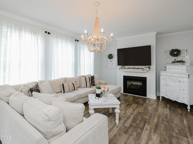 living area with ornamental molding, a chandelier, a fireplace, and wood finished floors
