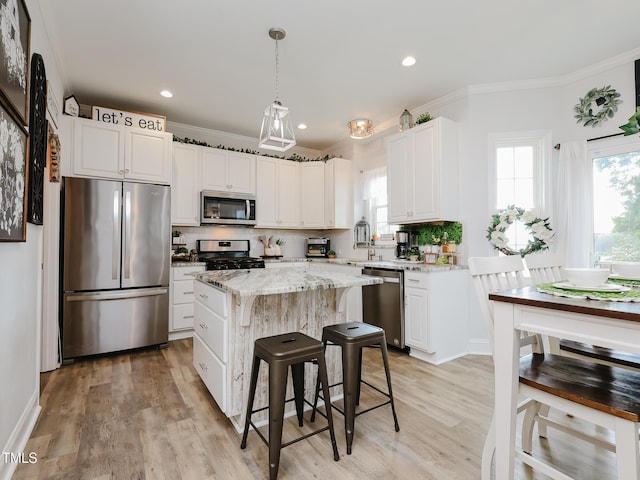 kitchen featuring stainless steel appliances, crown molding, light stone counters, backsplash, and white cabinetry