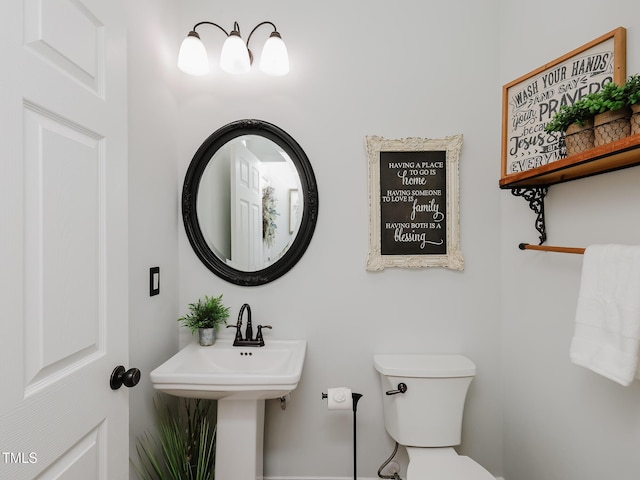 bathroom with toilet and a sink