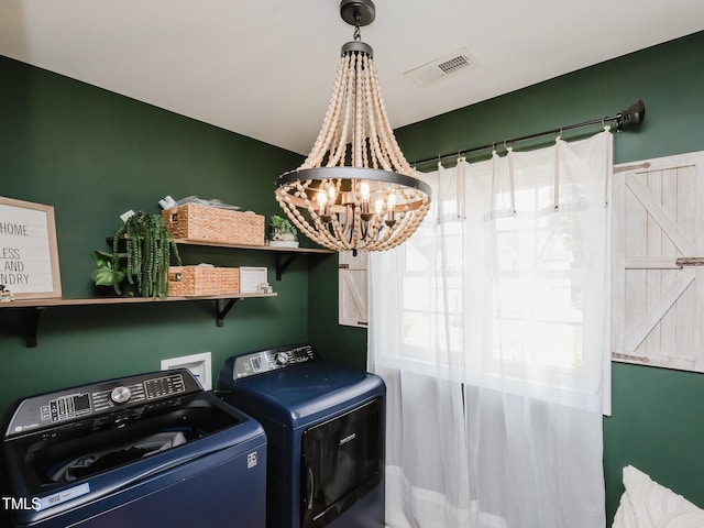 laundry area featuring independent washer and dryer, a chandelier, and healthy amount of natural light